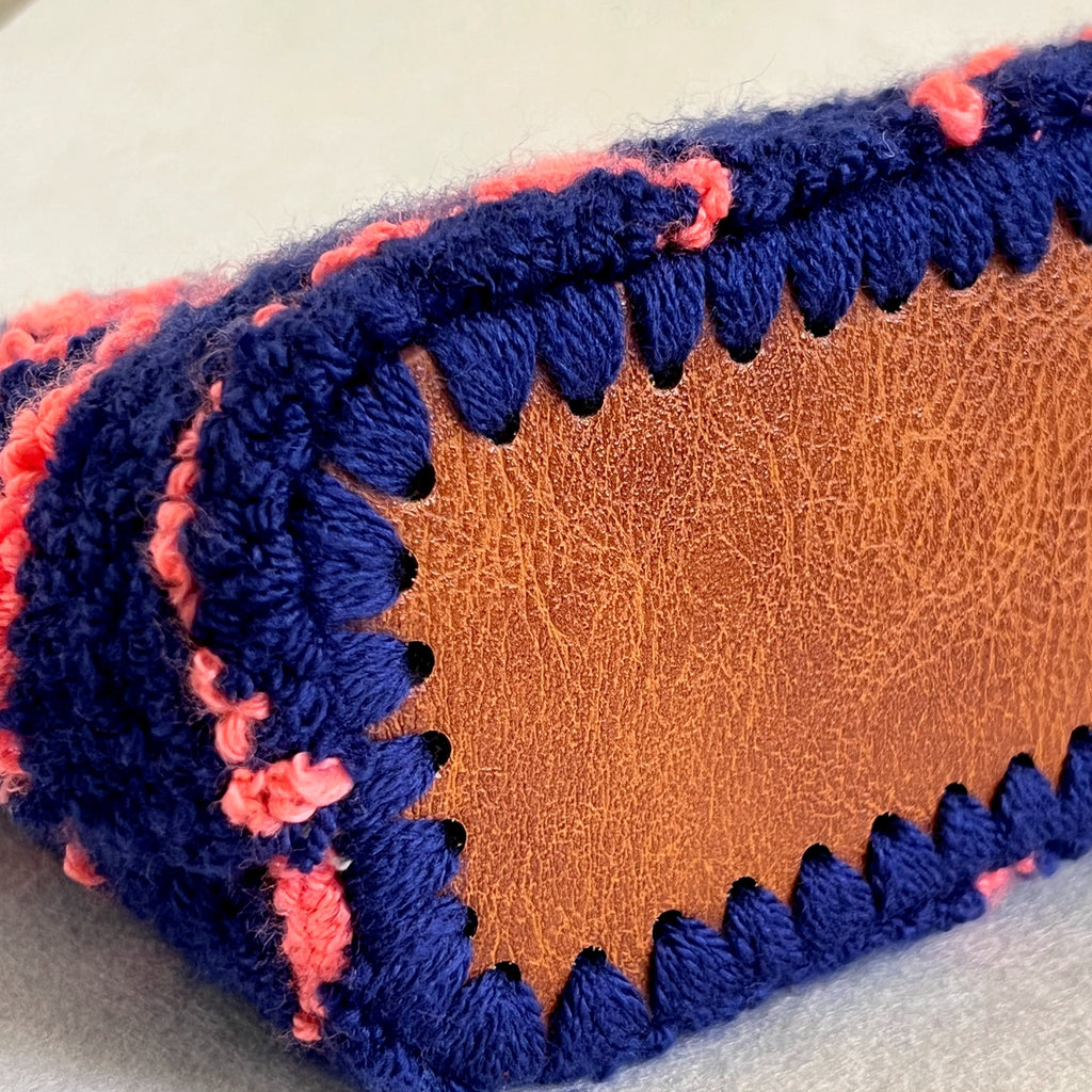 Hand-stitched faux leather bottom detail of Ohpunch Pochette Lido DIY punch needle bag.