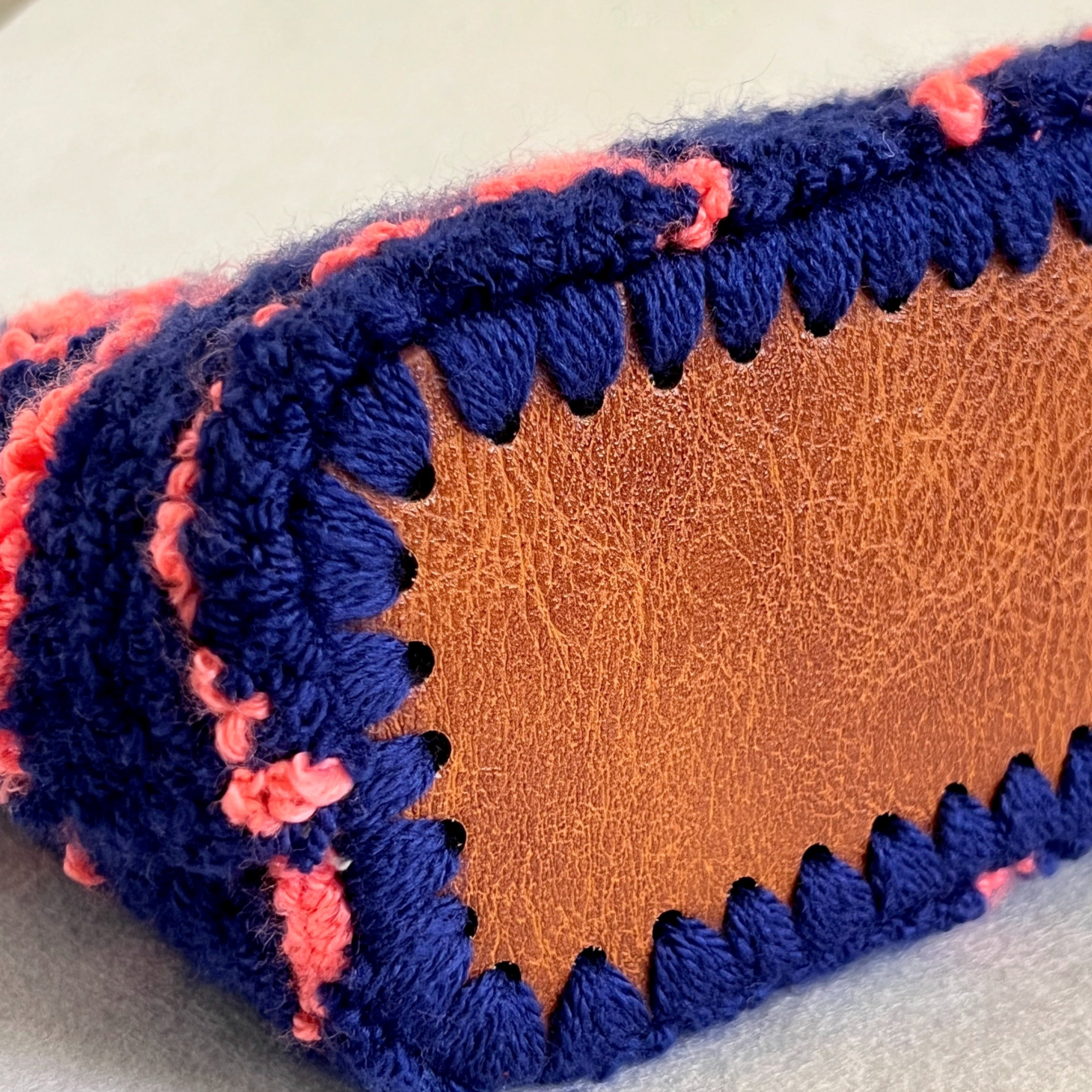 Hand-stitched faux leather bottom detail of Ohpunch Pochette Lido DIY punch needle bag.