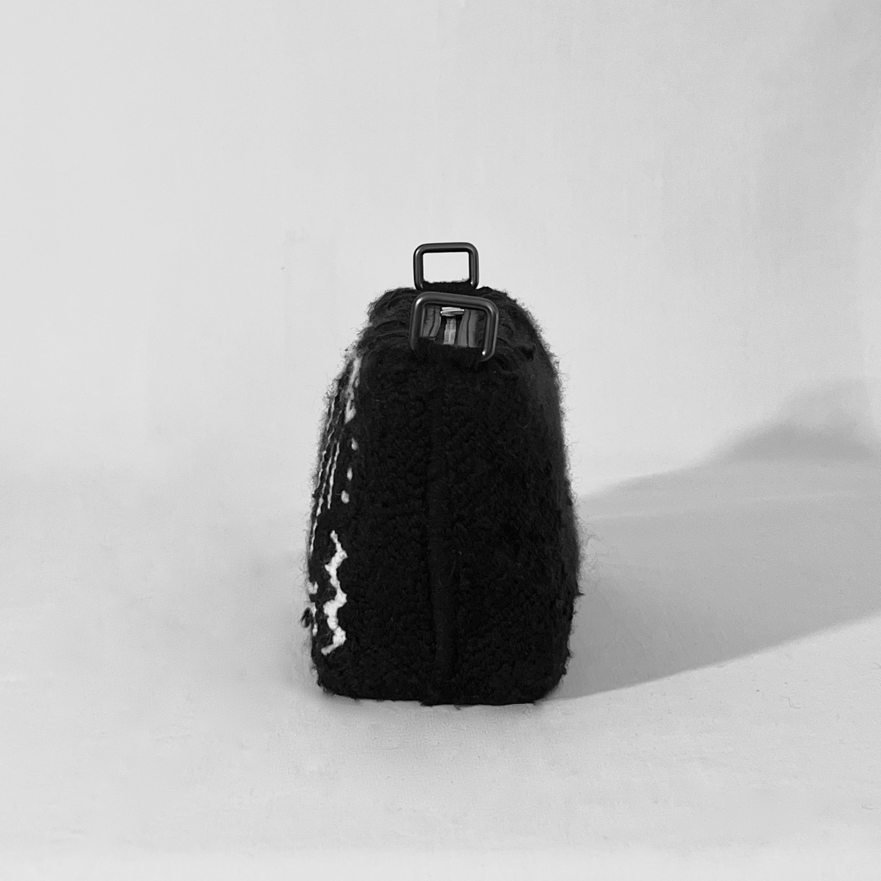 Back angled view of Ohpunch Water Cipher punch needle DIY pochette bag.