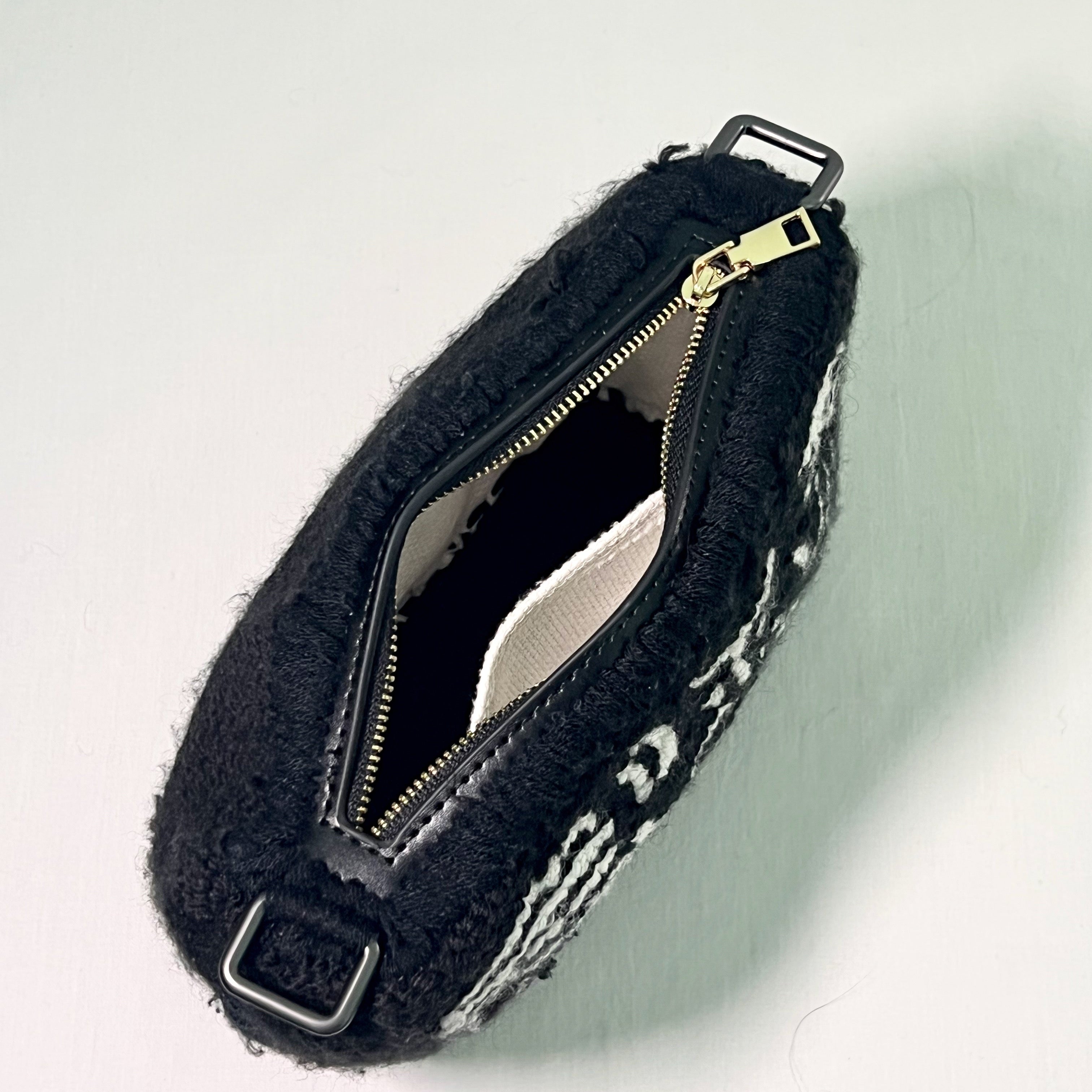 Top view of Ohpunch Pochette Water Cipher punch needle bag showing zipper closure.
